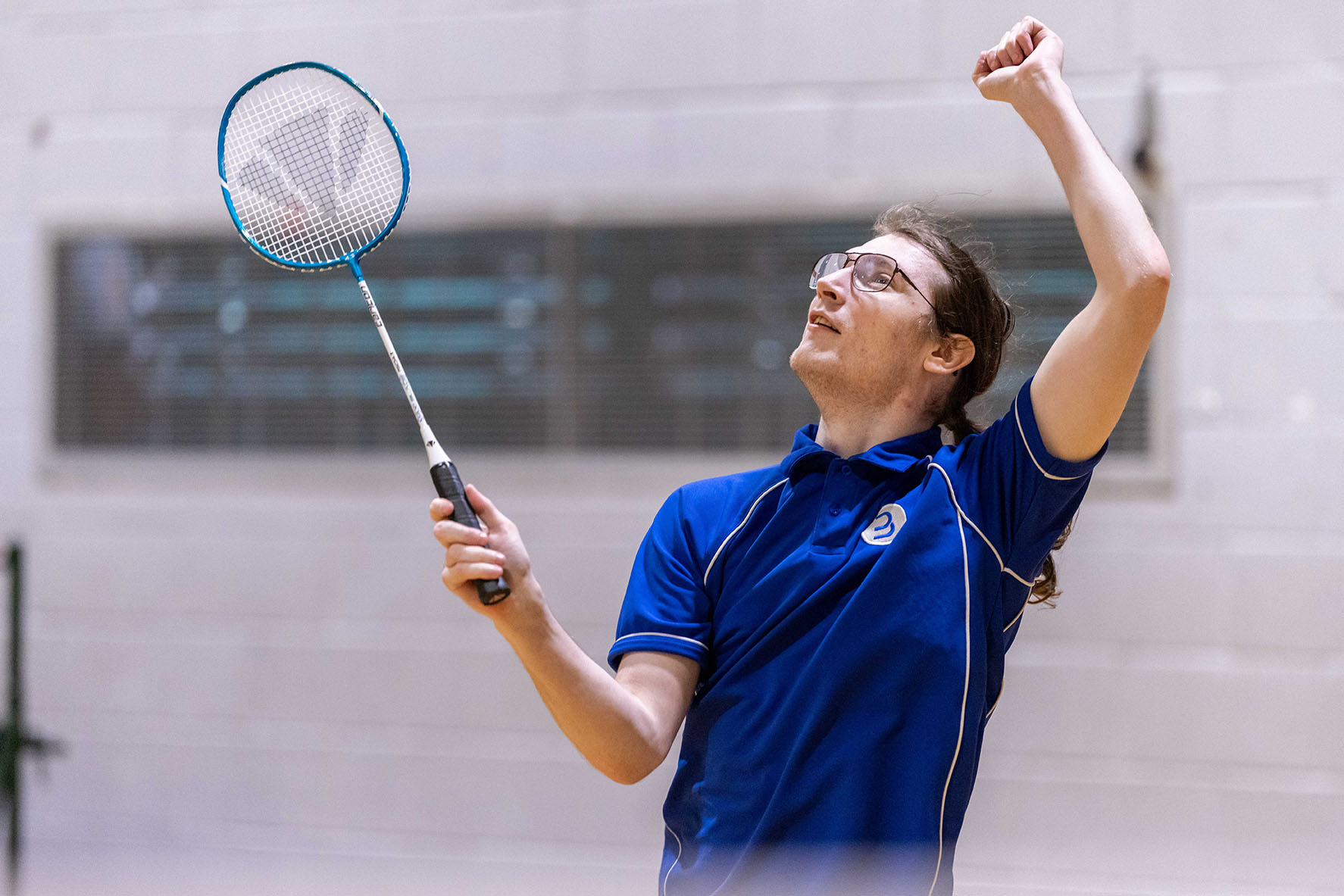 Man plays badminton on a court at Barrow Leisure